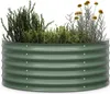 A green corrugated metal raised garden bed filled with various herbs and small plants. Podgląd zdjęcia produktu
