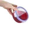 A hand holding a round food container filled with red liquid. Náhled obrázku produktu