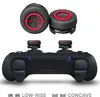 A black PlayStation controller with red and black thumbstick attachments shown from a slightly elevated front-side angle. The attachments are also shown from above. Produktbild-Vorschau