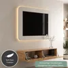 A modern TV board mounted on a wall with a TV above it, showcasing its open doors and soft-close feature. Produktbild-Vorschau