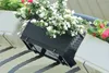 A close-up view of balcony planters filled with flowers, attached to a railing. Voir les images du produit