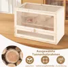 A hamster cage with a hamster inside, placed on a wooden table. The image also includes marketing text and icons at the bottom. Náhľad obrázku produktu