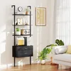 A living room scene with a black ladder shelf filled with books and decor, next to a white sofa and plants. Podgląd zdjęcia produktu