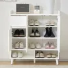 A white shoe cabinet with multiple shelves and doors, filled with various shoes. Produktbild-Vorschau