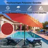 A red patio umbrella is set up next to a swimming pool with lounge chairs. Voir les images du produit