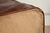 Close-up of the corner of a pouf, showing the transition from leather to fabric. Produktbild-Vorschau