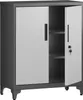 A gray metal cabinet with two doors, one of which is open, revealing shelves inside. The cabinet has black legs and black handles on the doors. A key is visible in the lock of the open door. Produktbild-Vorschau