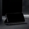 A black smartphone case with a phone inside, displayed in a studio setting with dark background. Produktbild-Vorschau