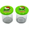 Two glass jars with green lids, each featuring a cartoon character wearing a Santa hat and text. Produktbild-Vorschau