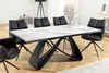 A dining table with chairs in a modern dining room setting. Produktbild-Vorschau