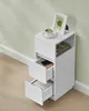 A white end table with two open drawers sits next to a pale green wall. Náhled obrázku produktu