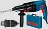 A Bosch hammer drill with accessories and a carrying case, displayed against a white background. Náhled obrázku produktu