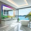 A modern bathroom with a large LED mirror, a freestanding bathtub, and a view of the ocean. Produktbild-Vorschau