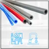 Several colored tubes of varying sizes are arranged diagonally across the image. Below the tubes, there are two blue line-art icons: one depicting a water heater and plumbing system, and the other showing a faucet with dripping water and dollar signs. Náhľad obrázku produktu