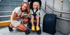 A woman and a child are on stairs next to a stroller and a backpack. Produktbild-Vorschau