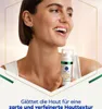 A woman is holding a NIVEA serum bottle, smiling. Anteprima dell’immagine prodotto