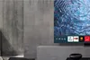 A modern living room with a concrete wall and a TV displaying various app icons. Produktbild-Vorschau