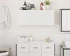 A clean, modern bathroom setting with a white wall-mounted cabinet. Produktbild-Vorschau