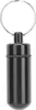 A black pill holder keychain on a white background. Produktbild-Vorschau