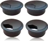 Four black cable grommets are arranged in a two-by-two grid against a white background. Produktbild-Vorschau