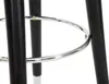 A close-up view of the lower part of a bar stool, focusing on the metal footrest ring and the black legs. Náhľad obrázku produktu