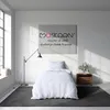 A bedroom scene with a bed, lamp, and artwork on the wall. Produktbild-Vorschau