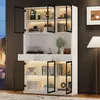 A white display cabinet with glass doors and LED lighting, showcasing various decorative items and books. Produktbild-Vorschau