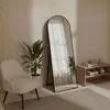 A room with a chair, a plant, a mirror, and a shelf. Produktbild-Vorschau