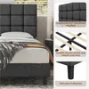 A bed frame with a padded headboard and details about its construction. Produktbild-Vorschau