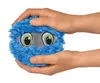 Hands holding a blue plush toy monster with large eyes. Produktbild-Vorschau
