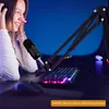 A young woman wearing headphones is using a microphone on a boom arm, with a keyboard and mouse visible on the desk. Produktbild-Vorschau