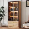 A tall wooden cabinet with glass doors and internal lighting, displaying various decorative items and books. Voir les images du produit