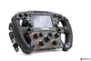 A racing steering wheel with a screen and multiple buttons, set against a white background. Produktbild-Vorschau