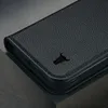 A close-up view of a black leather iPhone case with a bull logo embossed on it. Anteprima dell’immagine prodotto