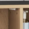 A close-up view of a cabinet hinge and a soap dispenser inside a cabinet. Produktbild-Vorschau