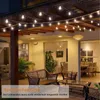 An outdoor patio area at night, decorated with string lights. Náhled obrázku produktu