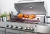 A stainless steel gas grill with chickens roasting on a rotisserie. Podgląd zdjęcia produktu