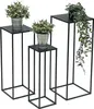 Three black metal plant stands of varying heights, each holding a potted plant. Anteprima dell’immagine prodotto
