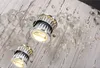 A close-up view of a modern chandelier with crystal accents and integrated LED lights. Náhled obrázku produktu