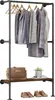 A clothing rack with clothes, a bag, a plant, and shoes. Produktbild-Vorschau