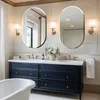 A modern bathroom vanity with two oval mirrors above it. Podgląd zdjęcia produktu