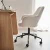 A white bouclé office chair with black wheels is positioned next to a wooden desk. Anteprima dell’immagine prodotto