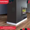 A modern fireplace with a black finish, featuring a glass door and a white base, set against a dark wall and wooden floor. Overlay text highlights a feature. Náhled obrázku produktu