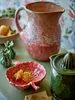 A still life arrangement of kitchenware and fruit. Produktbild-Vorschau