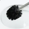 A close-up shot of a black toilet brush with a silver handle, positioned inside a white toilet bowl. Náhled obrázku produktu
