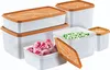 A collection of white plastic food storage containers with orange lids, some filled with frozen raspberries and peas. Produktbild-Vorschau