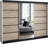 A modern sliding door wardrobe with mirrored doors reflecting a living room scene with a sofa. Produktbild-Vorschau