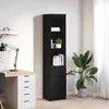 A tall, black bookshelf with drawers is shown next to a desk with a lamp and a potted plant. Náhľad obrázku produktu
