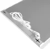 A close-up, angled view of a silver infrared heating panel with a white power cord and plug. Anteprima dell’immagine prodotto