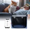 A cat sits on a couch next to a sleeping person, with a pet oxygen chamber and a nebulizer in the foreground. Produktbild-Vorschau